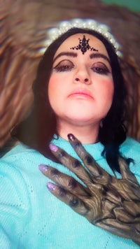 Claudia dressed as a ghoul clown in her show In My Room.